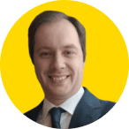 A man in a suit and tie, representing the EUD Board, smiles at the camera against a yellow circular background.