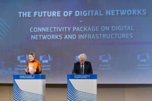 Margrethe Vestager and Thierry Breton stand at two separate lecterns in front of a screen displaying the text “The Future of Digital Networks: Connectivity Package on Digital Networks and Infrastructures”.